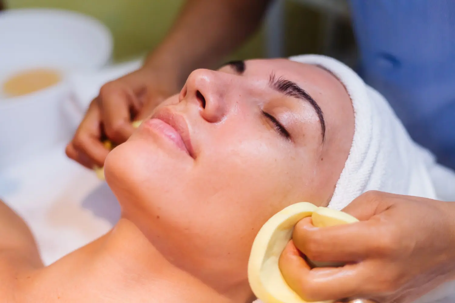 Young woman lying on cosmetologist's table during rejuvenation procedure. Young woman lying on cosmetologist's table during rejuvenation procedure.<br />